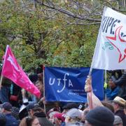 Flags and banners at rally, including UTFA banner, CUPE Ontario banner, and CUPE 3903 banner